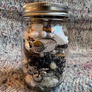 Jar filled with mystery costume jewelry.